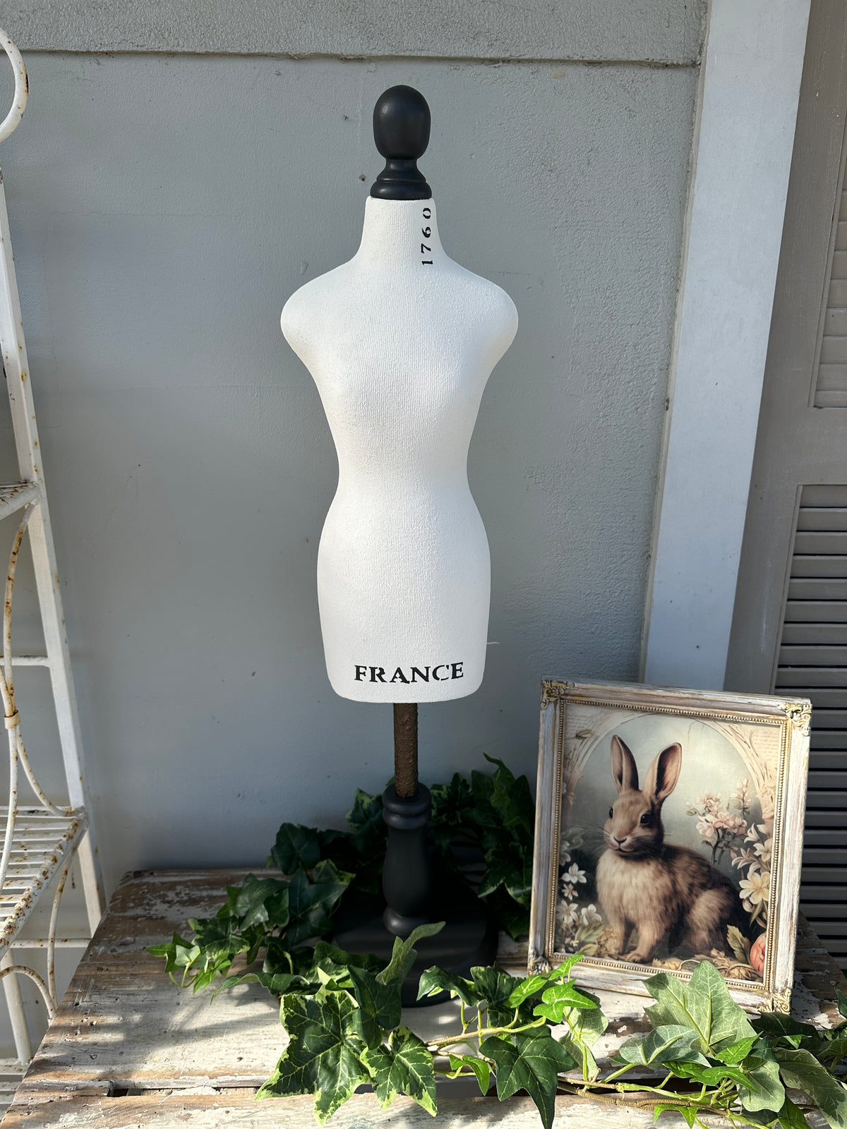 Mannequin torso with 'France' branding against a neutral wall. Tabletop Bust Stand