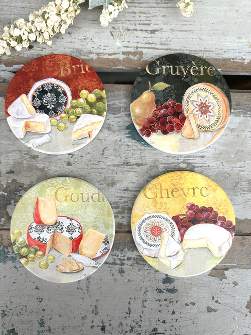 Set of four cheese-themed coasters on a wooden surface with floral decorations. Coaster set Cheese set of 4