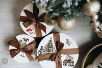 Redesign with Prima transfer middy Whimsical Holiday Dreams 4 sheet Decorative gift boxes with Christmas designs and ribbons on a wooden surface.
