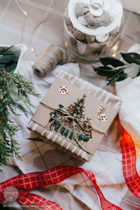 Redesign with Prima transfer middy Whimsical Holiday Dreams 4 sheet Gift box with Christmas design on a decorative surface with ribbons and greenery