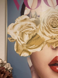 Close-up of a magazine cover with a woman's face partially obscured by gold roses. Vogue Canvas Framed