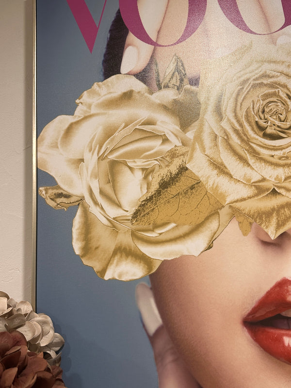 Close-up of a magazine cover with a woman's face partially obscured by gold roses. Vogue Canvas Framed