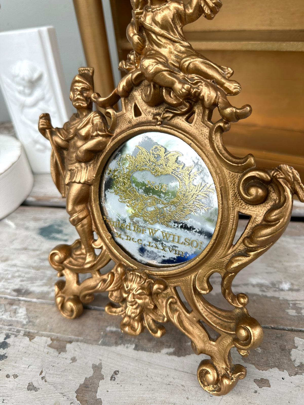 Very old cast frame with mirror inset