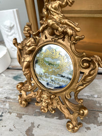 Very old cast frame with mirror inset