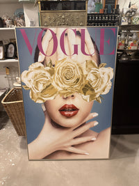 Vogue magazine cover with gold roses and a woman's face on a textured surface