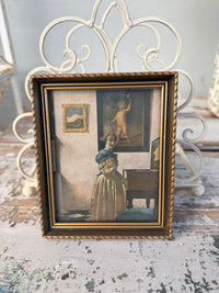 Framed vintage-style portrait of a child in a decorative setting