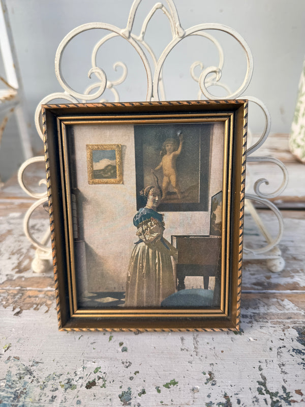 Framed vintage-style portrait of a child in a decorative setting