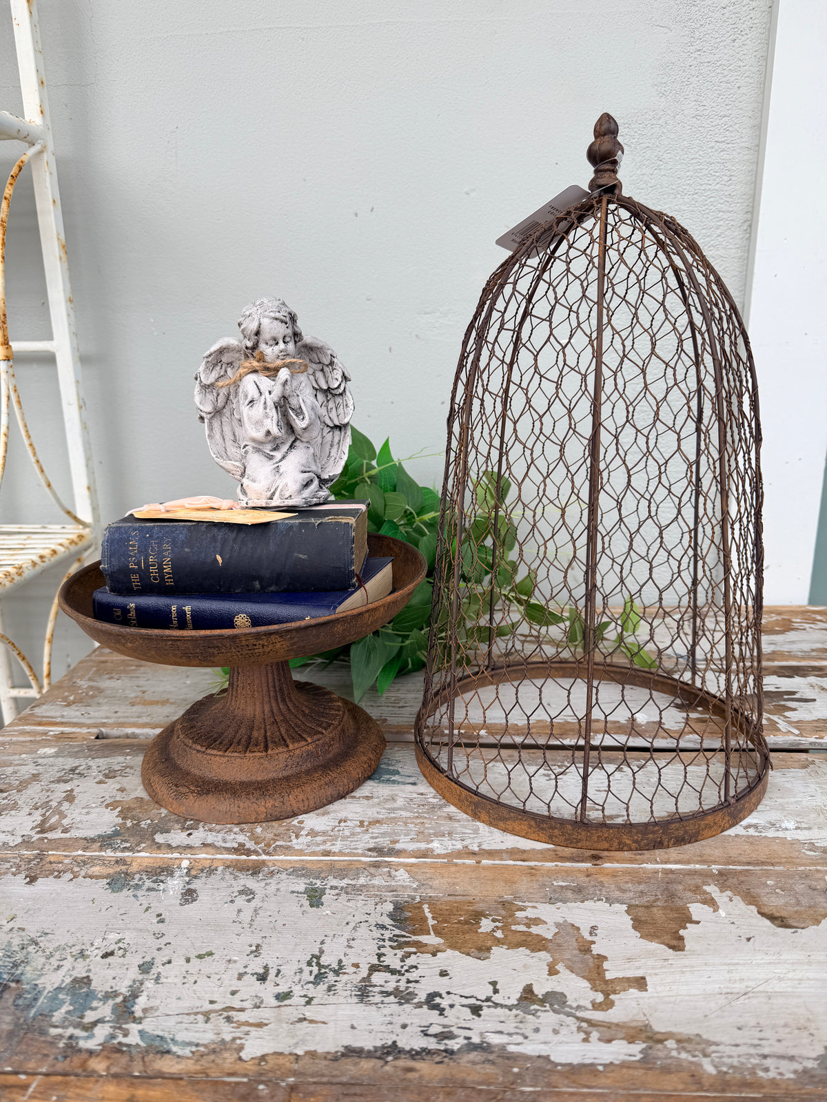 A rustic metal birdcage planter  with the Maison Garden Cloche.