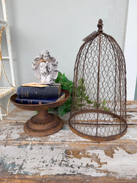 A rustic metal birdcage planter  with the Maison Garden Cloche.