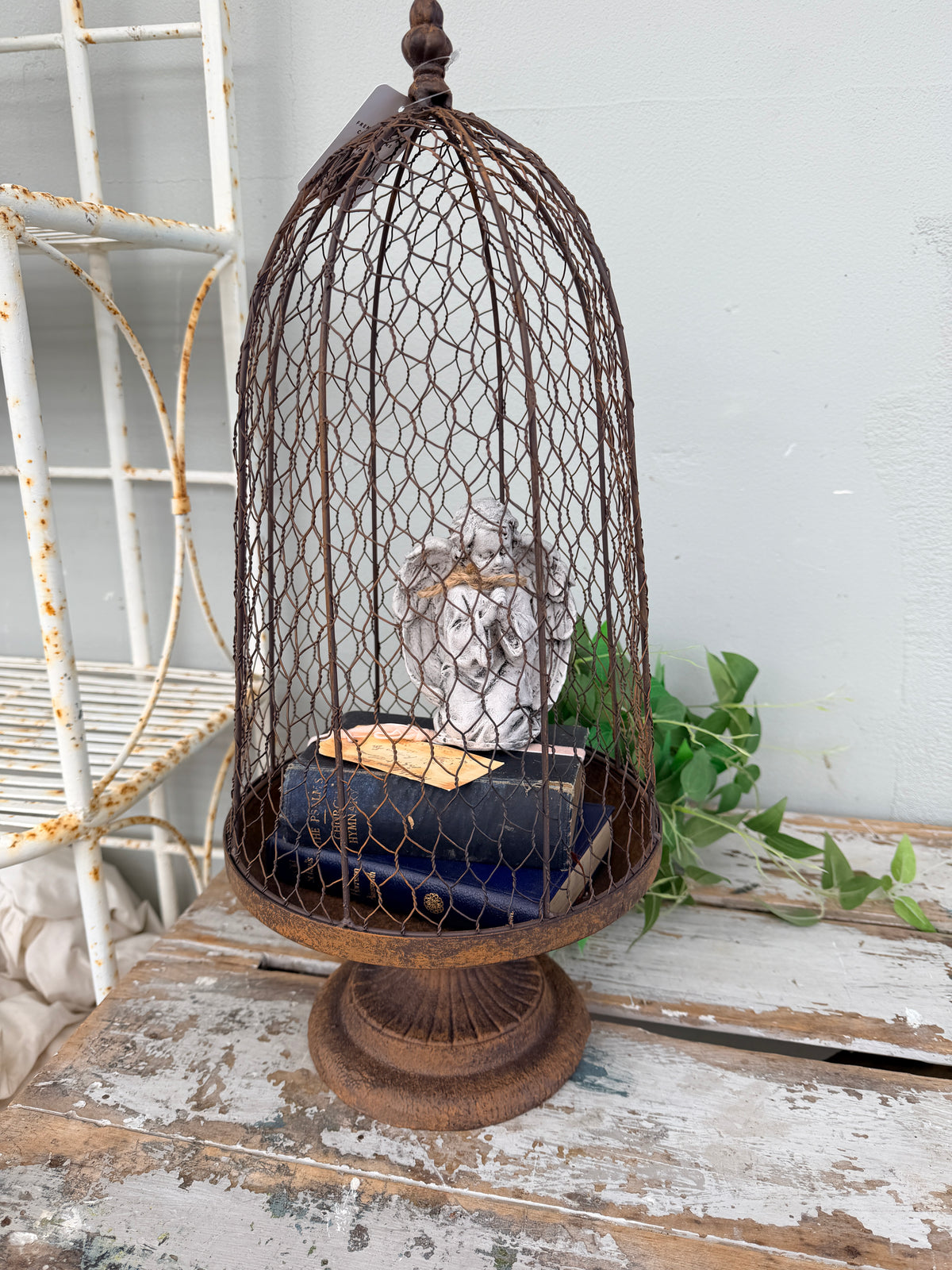 A rustic metal birdcage planter  with the Maison Garden Cloche.