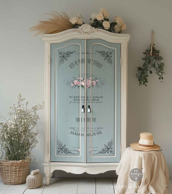 Decorative armoire with floral designs and text in a room with plants and a table. Redesign transfer Large My Heart