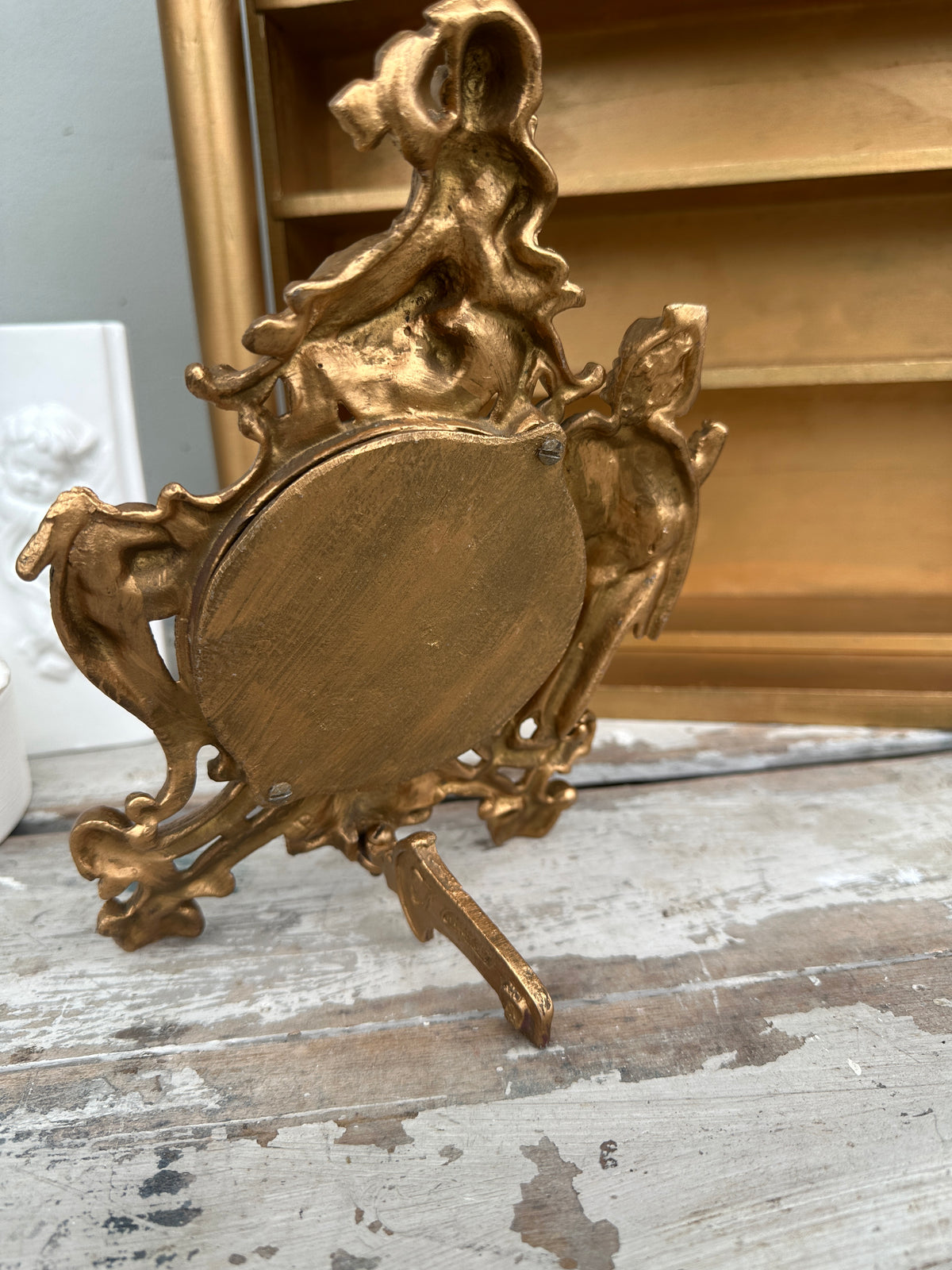 Very old cast frame with mirror inset