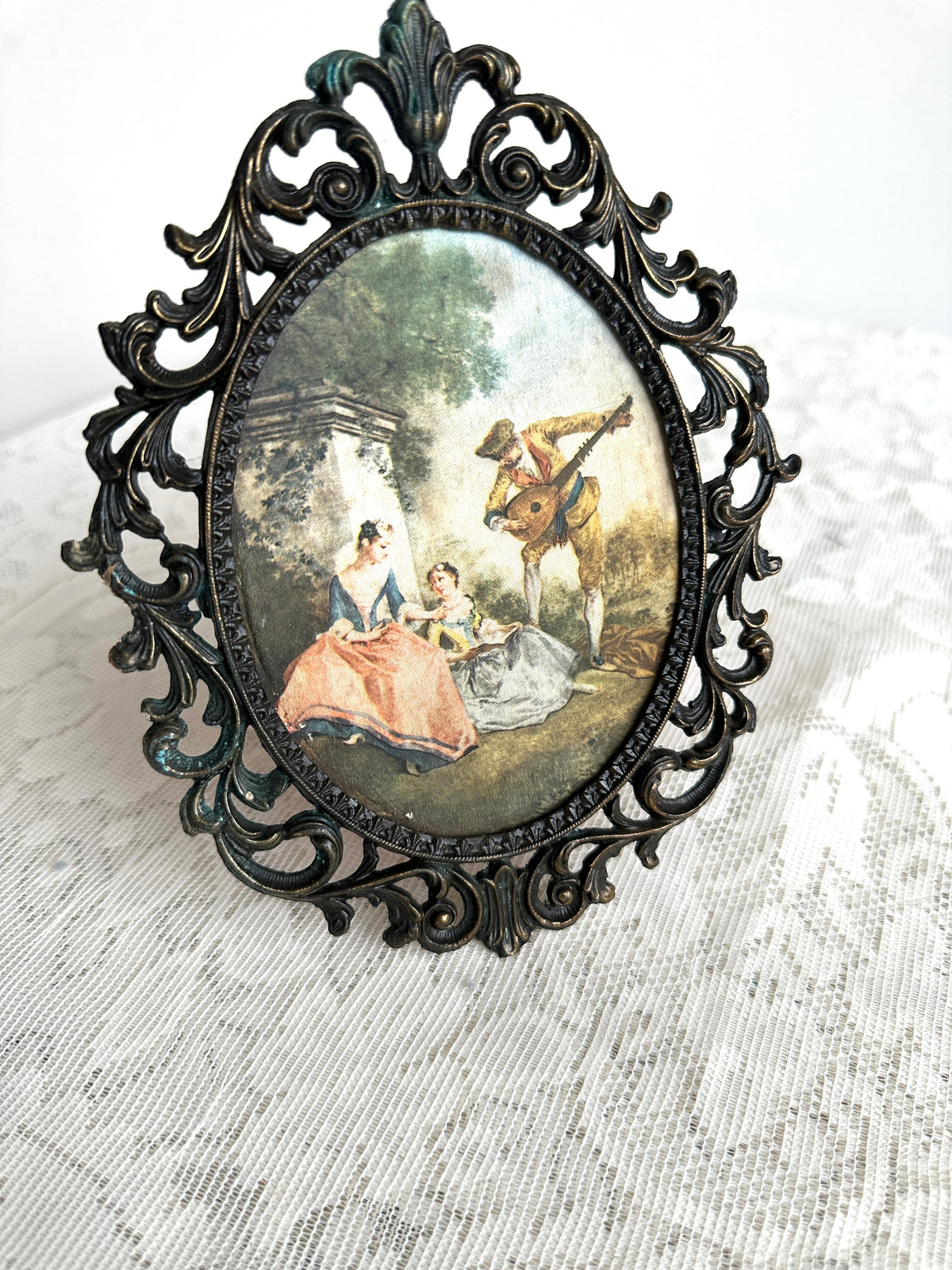 Metal filigree frame with vintage renaissance picture