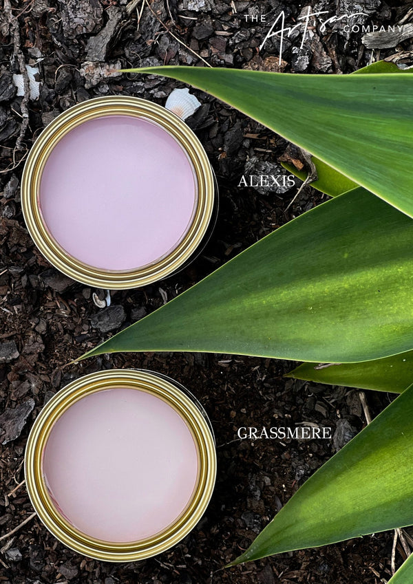 Two cans of paint labeled 'Alexis' and 'Grassmere' on a natural background with leaves. artisan paint