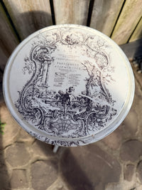 Decorative round table with intricate black designs on a stone surface