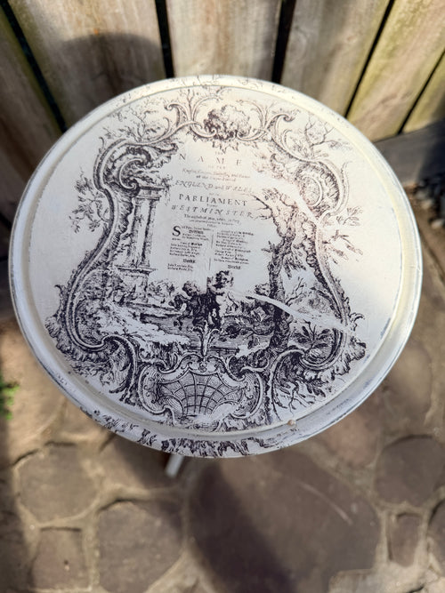 Decorative round table with intricate black designs on a stone surface