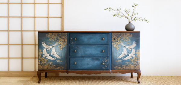 Blue dresser with Three white cranes flying against a textured blue and gold background. Golden Flight Mulberry Decoupage Paper