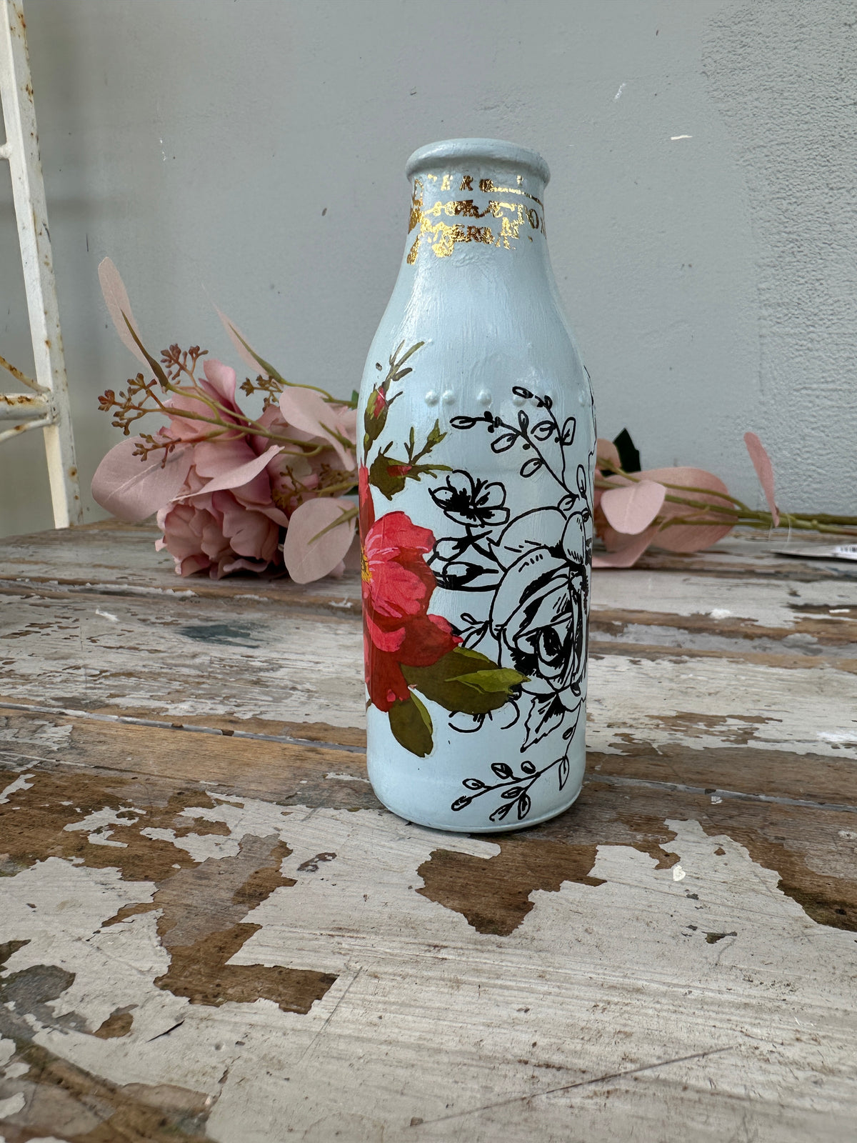 Painted glass mini milk bottle Blue w red and black floral