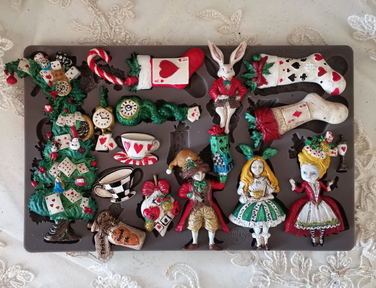 Collection of decorative figurines inspired by Alice in Wonderland on a dark surface. Whimsical Holiday Dreams Mould by Redesign with Prima