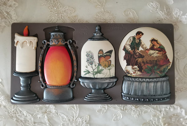 Decorative mold set with candle, lantern, and couple design on a textured surface. Glitter and Glow Mould by Redesign with Prima