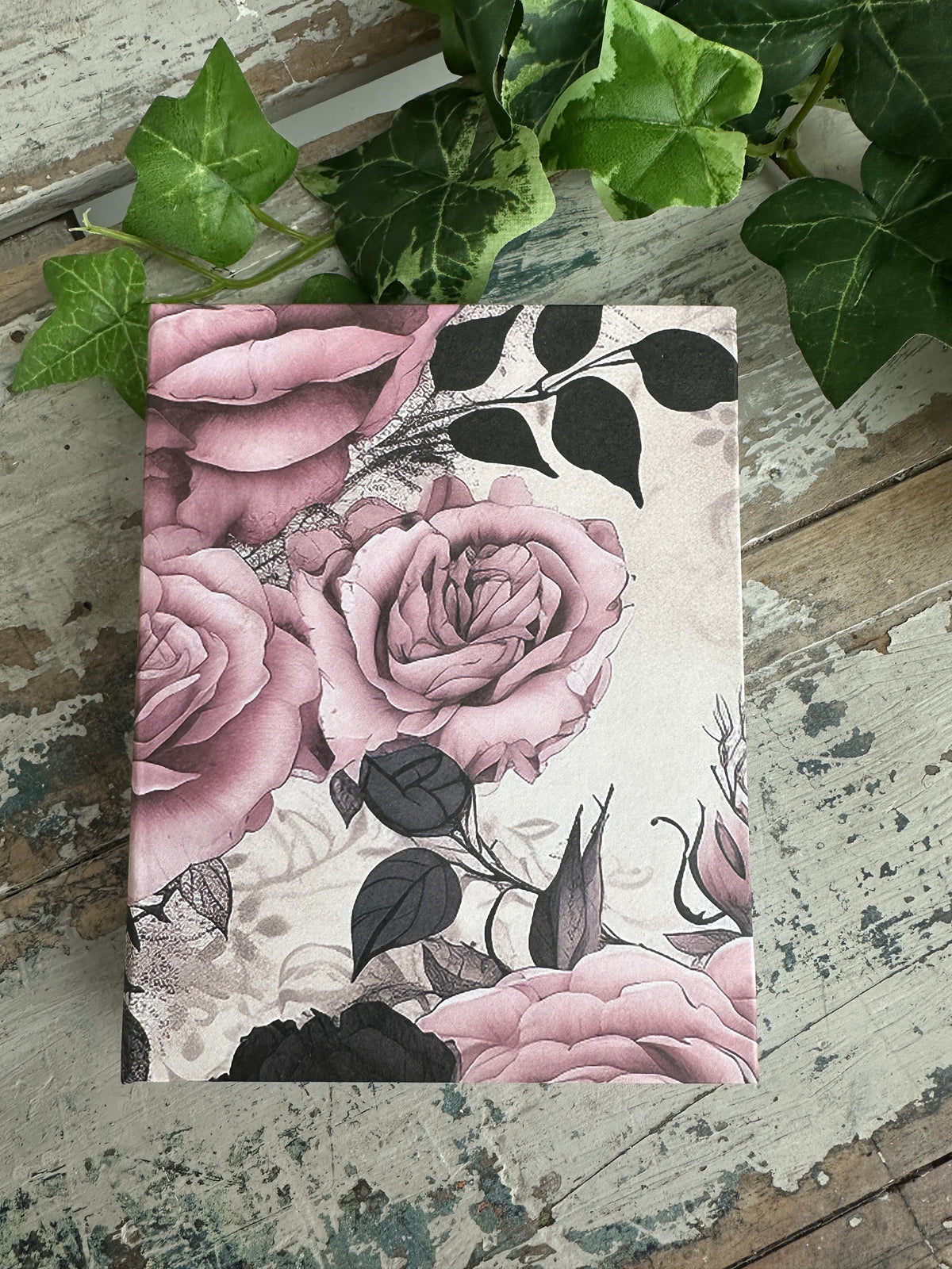 Jotter Pad O'Hara Roses Floral design with pink roses and black leaves .