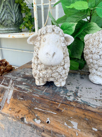 textured sheep figurine in a distressed off-white concrete finish