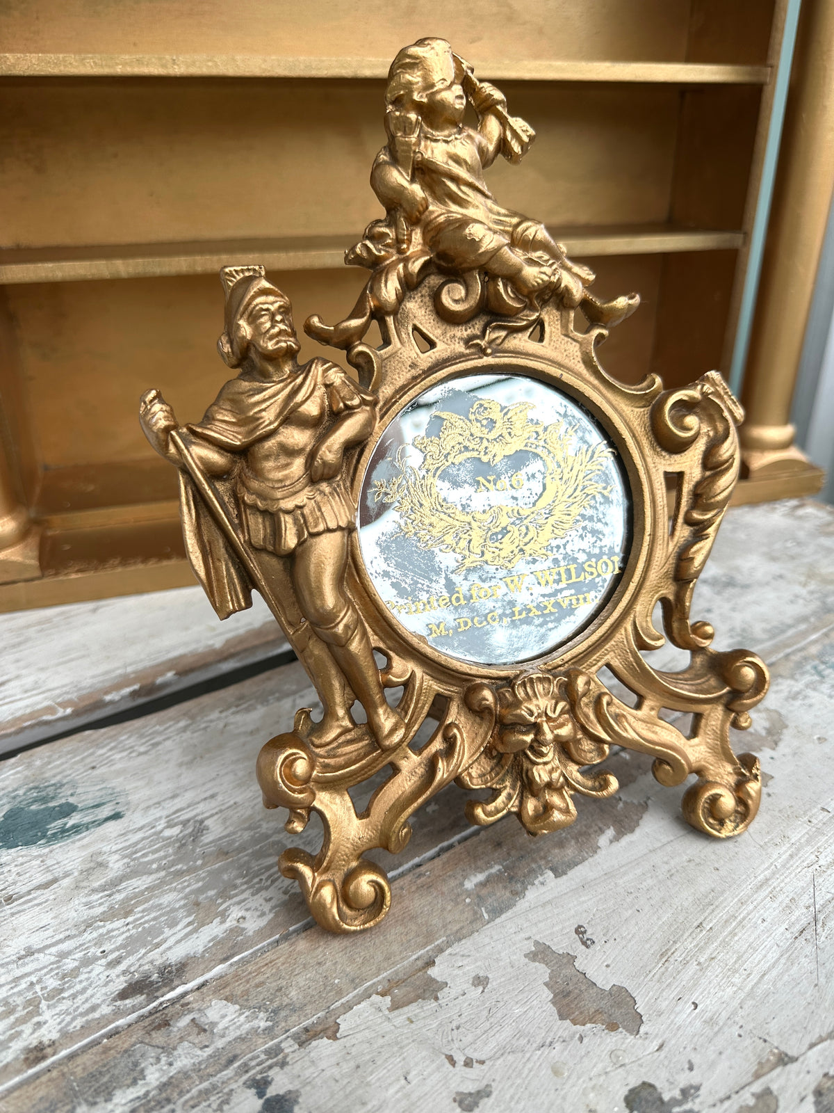 Very old cast frame with mirror inset