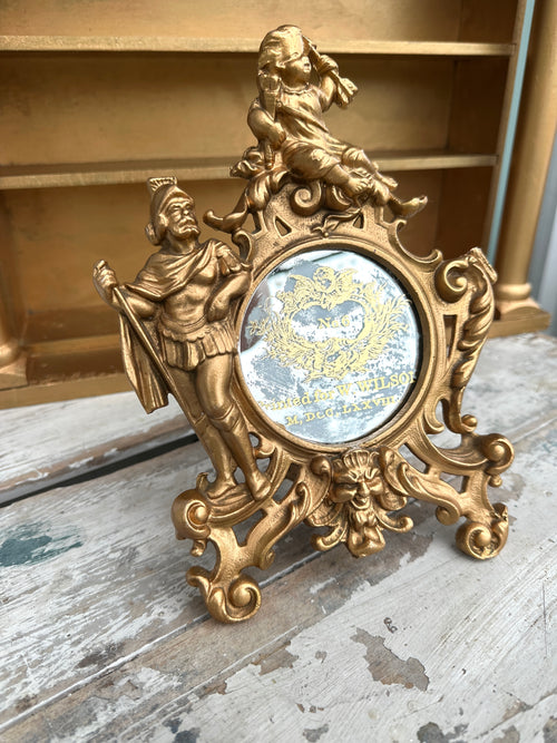 Very old cast frame with mirror inset