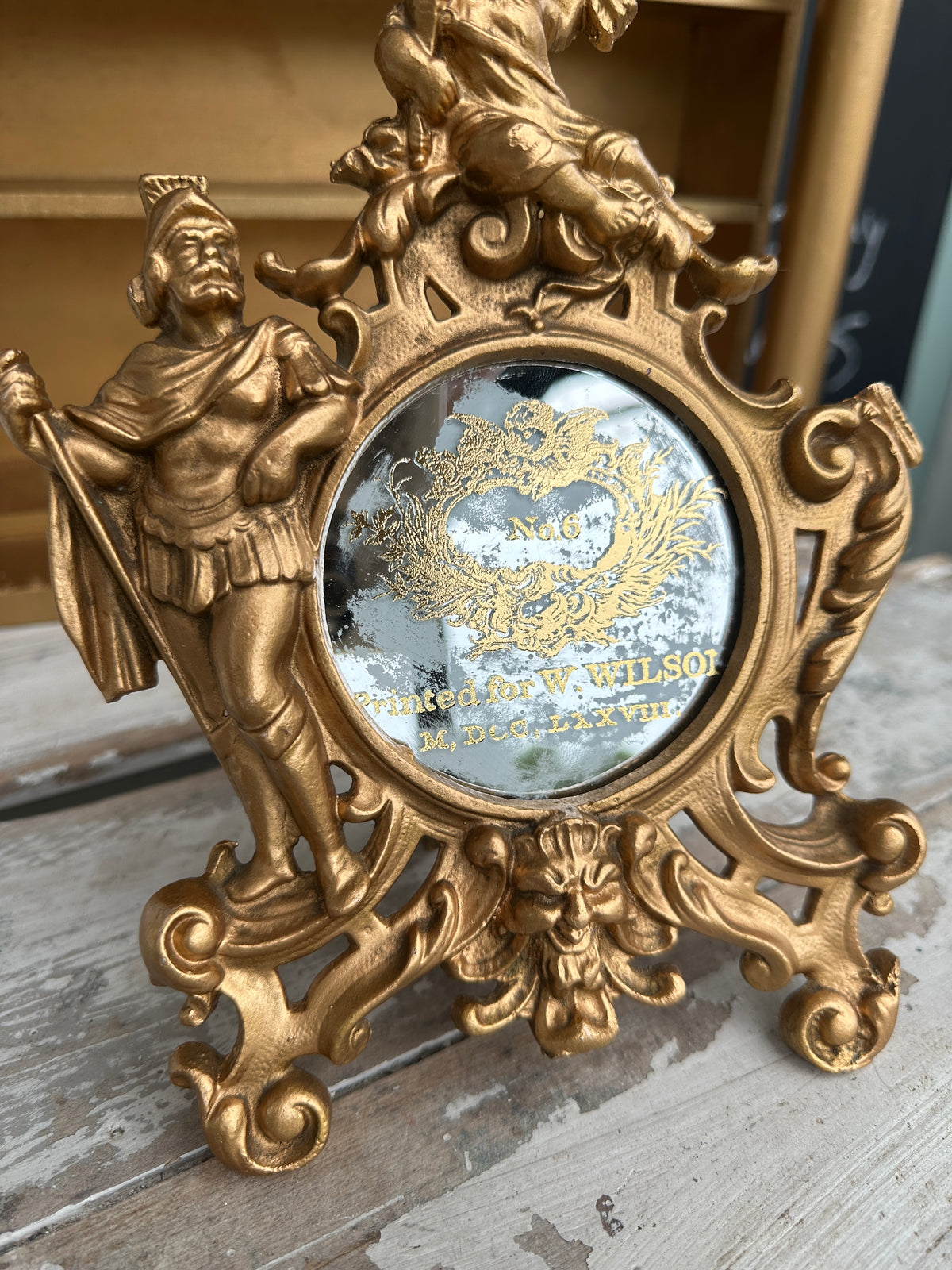 Very old cast frame with mirror inset