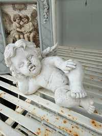 Old aged chippy Cherub statue