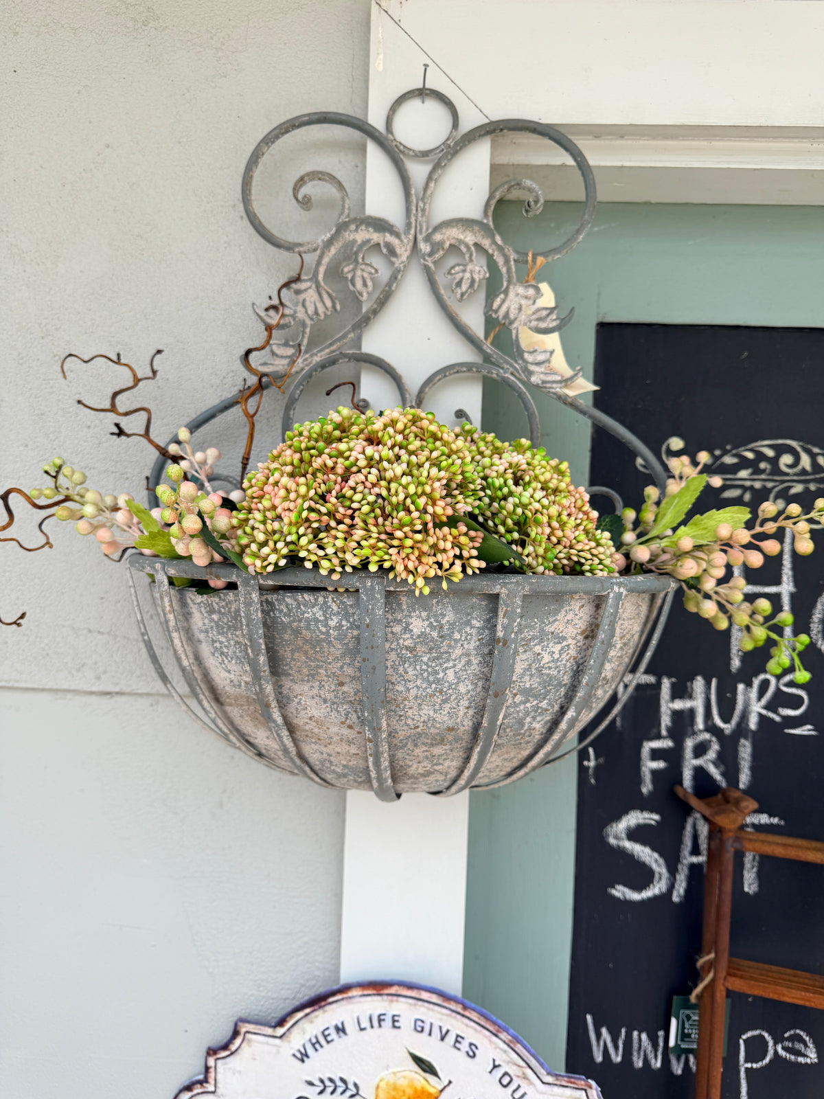 A rustic French grey metal hanging planter with intricate filigree design, .
