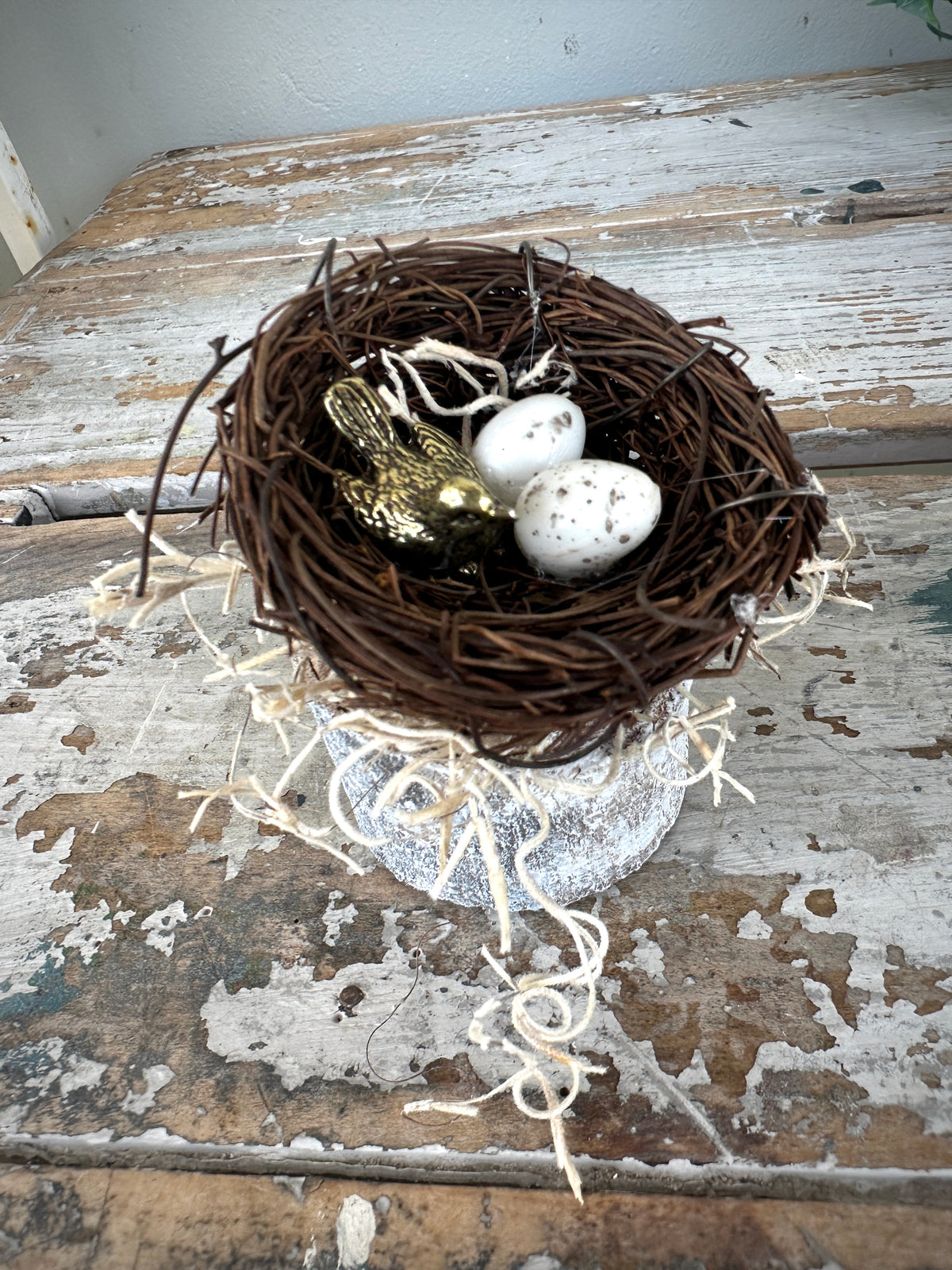 Mini Brass bird & eggs in nest on wooden log