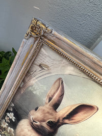 Framed artwork of a rabbit with decorative elements on a plain wall. Bunny Artwork
