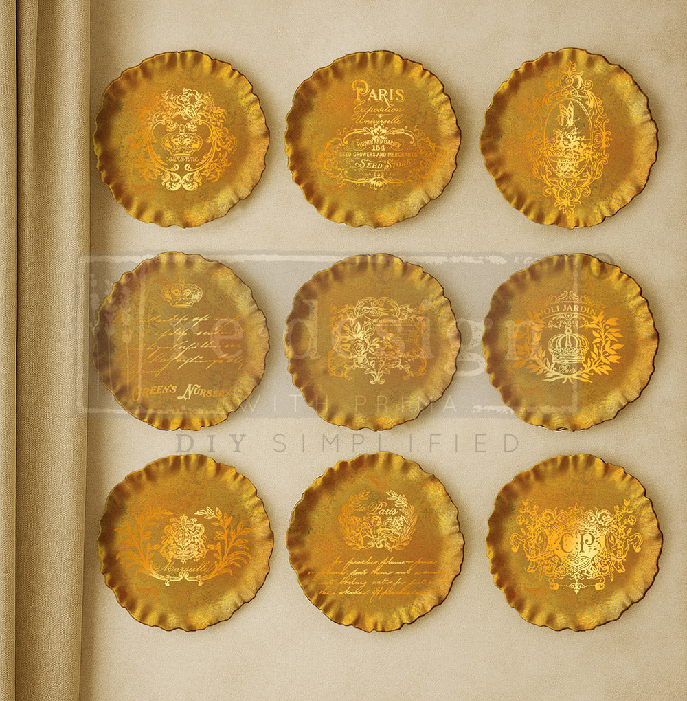 Set of gold decorative plates with intricate designs on a beige . Contours of Grace Mould by Redesign with Primabackground