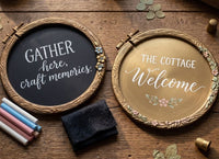 Two decorative signs with text on a wooden surface . Silicone mould DIY with engraved concentric circle patterns and two matching circular metal hoops , like embroidery hoops. Artisan's Frame Mould by Redesign with Prima