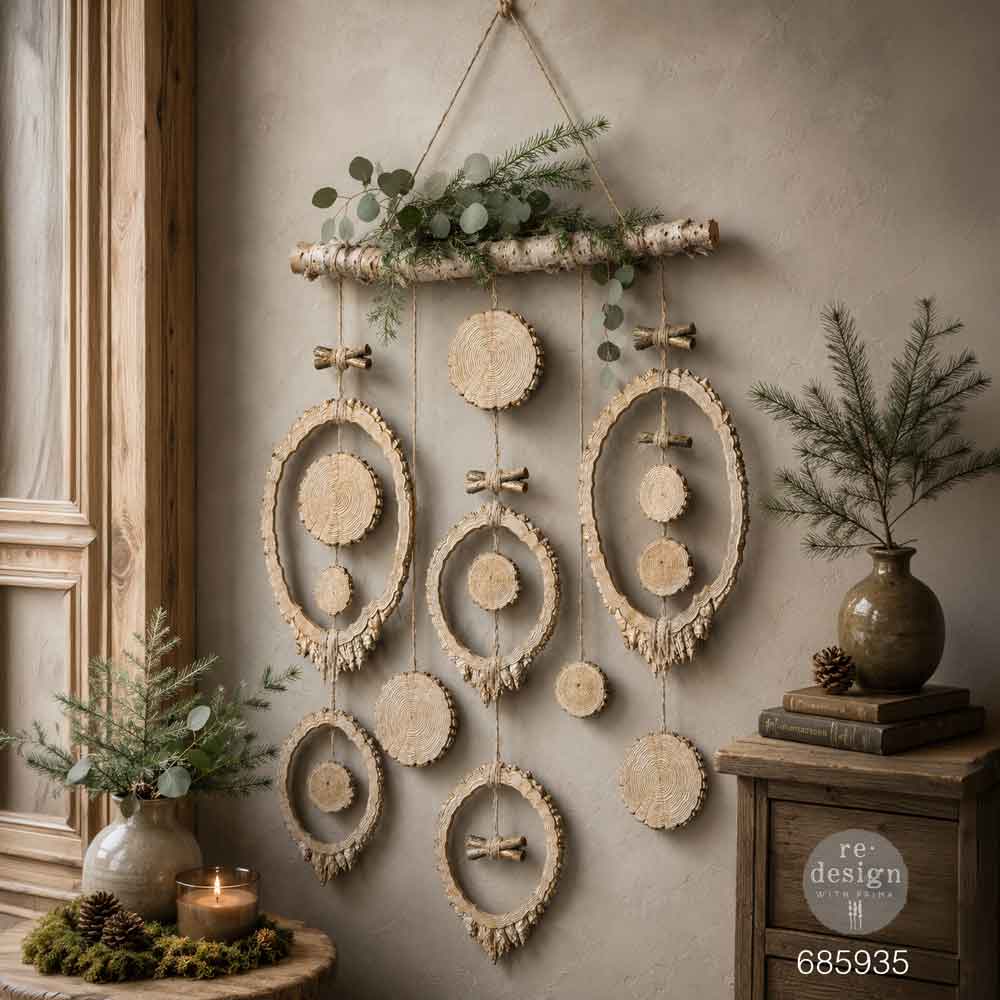 Decorative wall hanging with natural elements on a neutral wall. Carved wooden decorative pieces silicone mold. Evergreen & Embers Mould by Redesign with Prima