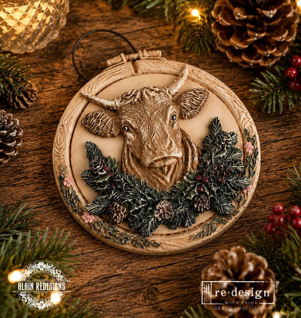 Silicone mold with Christmas-themed designs including a bull, stars, bows, and pine cones. Winter Barnstead Mould by Redesign with Prima