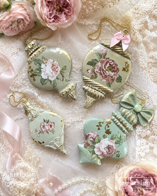 Decorative Christmas ornaments with floral designs on a lace background. Christmas Ornament mould set shown with the blank mold on the left and the cast  ornament pieces on the right. Winter Luxe Blanks Mould by Redesign with Prima