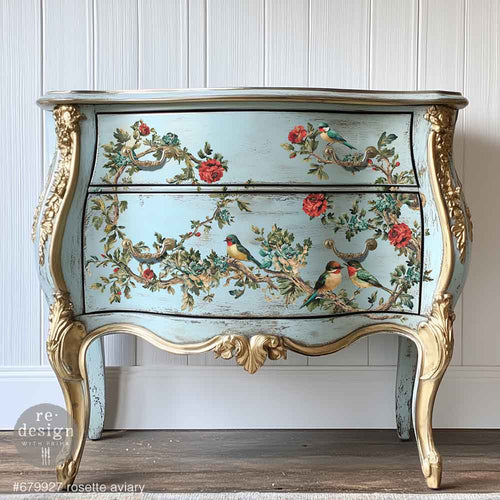 Redesign transfer Large Rosette Aviary. Decorative chest of drawers with floral and bird design on a white paneled wall.