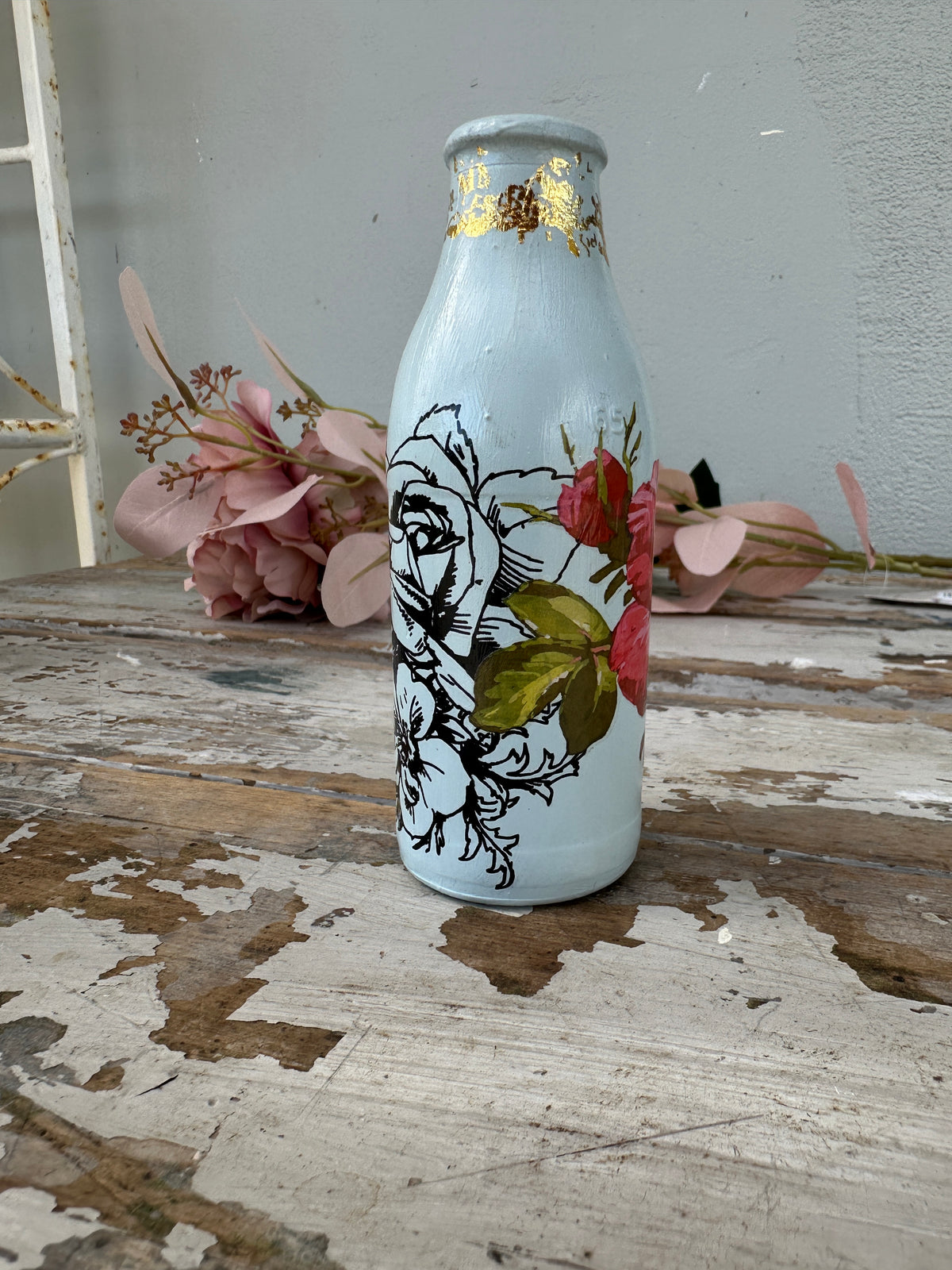 Painted glass mini milk bottle Blue w red and black floral