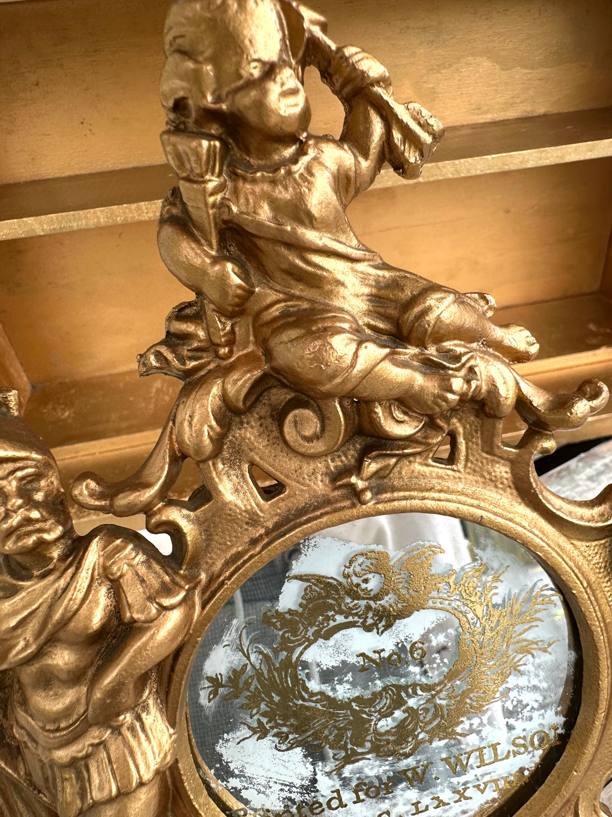 Very old cast frame with mirror inset