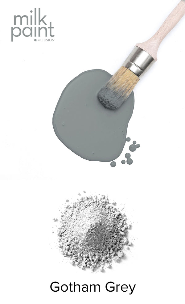 Milk paint in Gotham Grey with a brush and powder on a white background