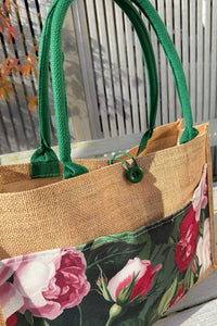 A jute tote bag with green handles and a floral print lower panel featuring pink and white roses, Garden Amour Jute Bag  by Annah Stretton
