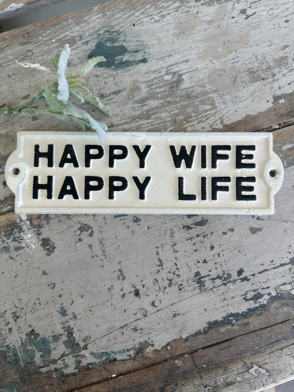 Decorative sign with 'WIFE HAPPY LIFE' text on a rustic wooden background