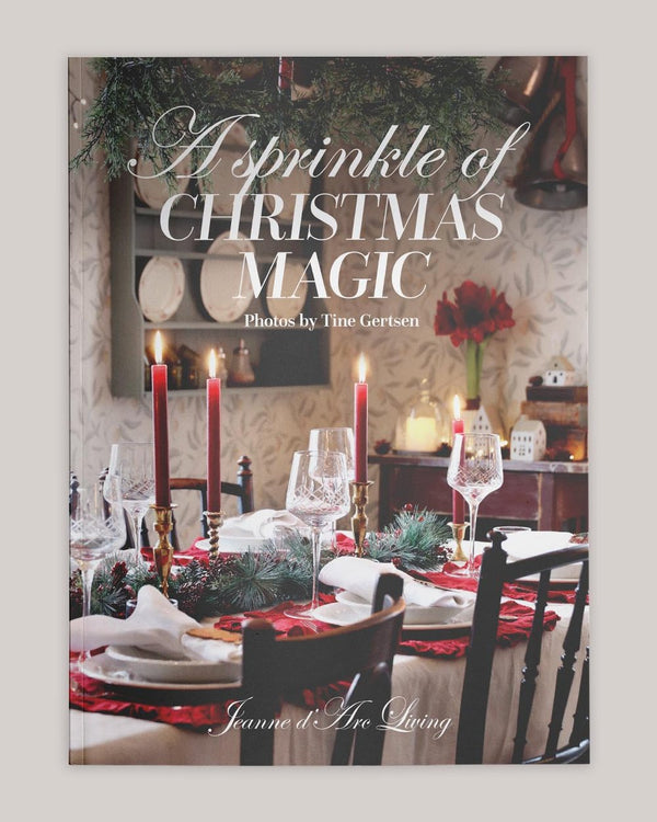 Book cover titled 'A Sprinkle of Christmas Magic' with a festive table setting.