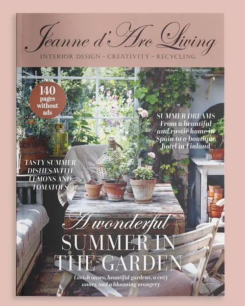Magazine cover of 'Jeanne d'Arc Living' featuring a garden scene with plants and furniture.