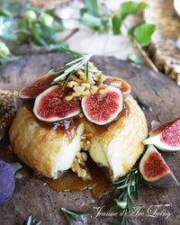 Baked brie with figs and nuts on a wooden board Issue 6 2025 Jeanne d'Arc Living Magazine