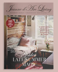 Jeanne d'Arc Living magazine cover featuring a cozy interior design scene with a bed, window, and text overlays including 'Golden LATE SUMMER MAGIC' and '140 pages without ads'.