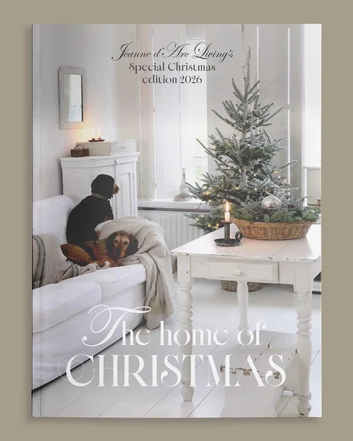 Magazine cover featuring a cozy living room with a Christmas tree and text about a special Christmas edition. Christmas Special 2026 Jeanne d'Arc Living Magazine