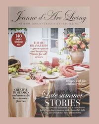 Magazine cover of 'Jeanne d'Arc Living' with a table setting and flowers. Issue 6 2025 Jeanne d'Arc Living Magazine